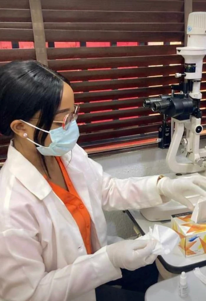 Optometrist examining patient